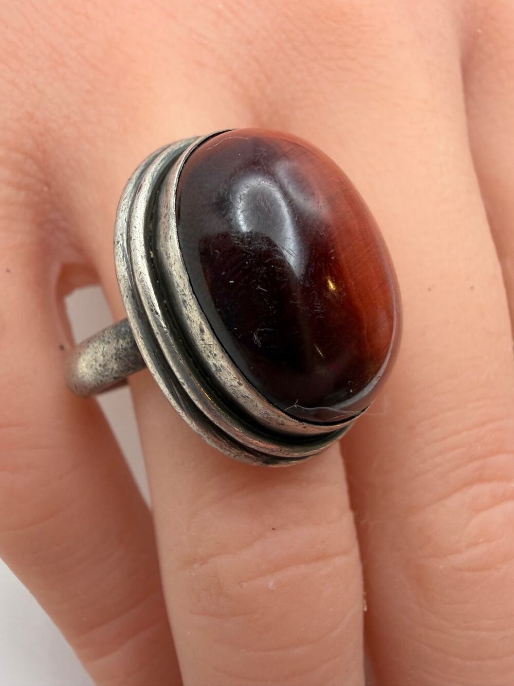 oval-cut red tiger's eye gemstone with a smooth cabochon finish sterling silver